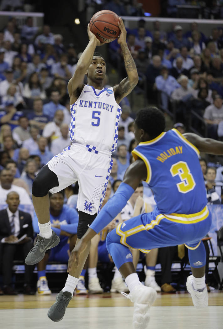 Kentucky guard Malik Monk shoots against UCLA guard Aaron Holiday in the first half of an NCAA college basketball tournament South Regional semifinal game Friday, March 24, 2017, in Memphis, Tenn. ...