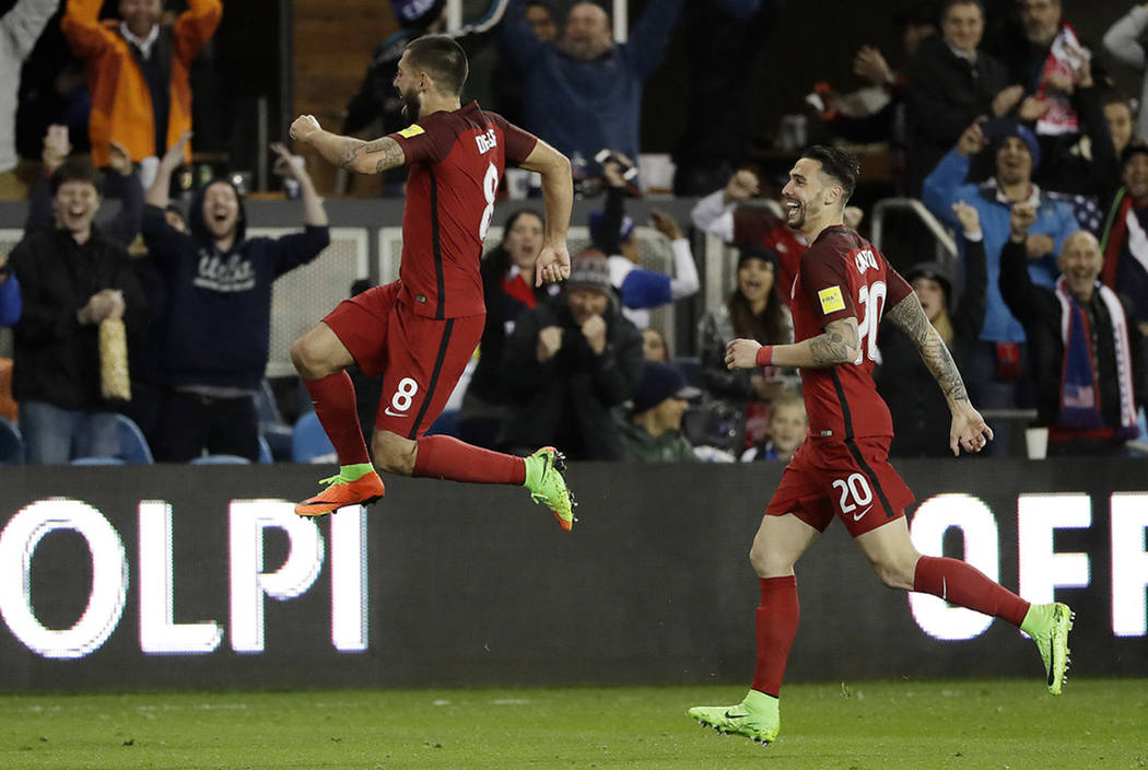 United States' Clint Dempsey, center, celebrates his free-kick goal with teammate Geoff Cameron, right, during the second half of a World Cup qualifying soccer match against Honduras on Friday, Ma ...