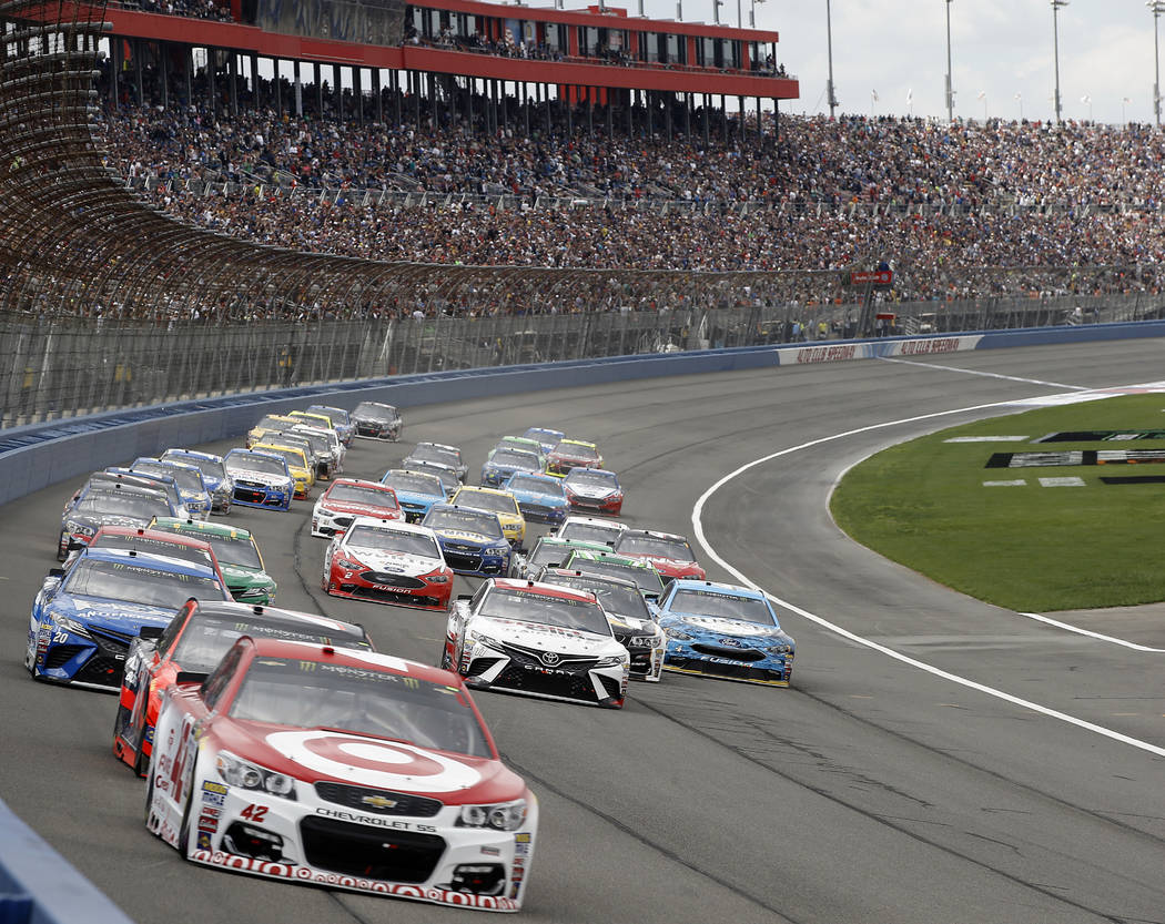 Kyle Larson (42) leads Martin Truex Jr., in second car, and the rest of the pack early in the NASCAR Cup Series auto race at Auto Club Speedway in Fontana, Calif., Sunday, March 26, 2017. (AP Phot ...