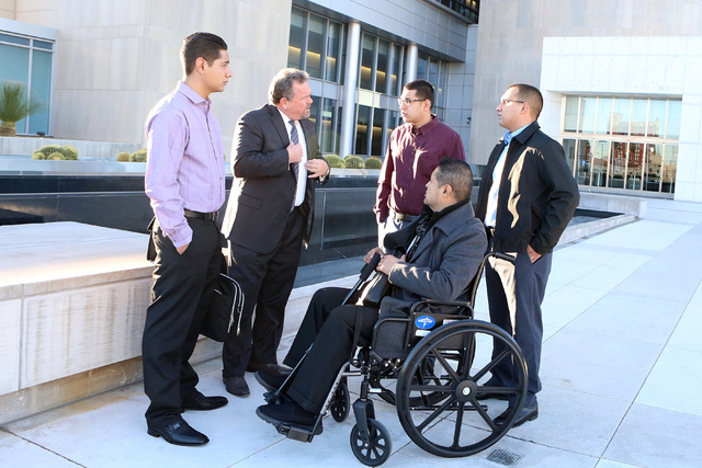 Defense attorney Brent Bryson, second left, discusses with his clients Henry Rodriguez, left,  Jordhy Leal, center, Jesus Sandoval and David Madue, right, about their civil trial against Las Vegas ...