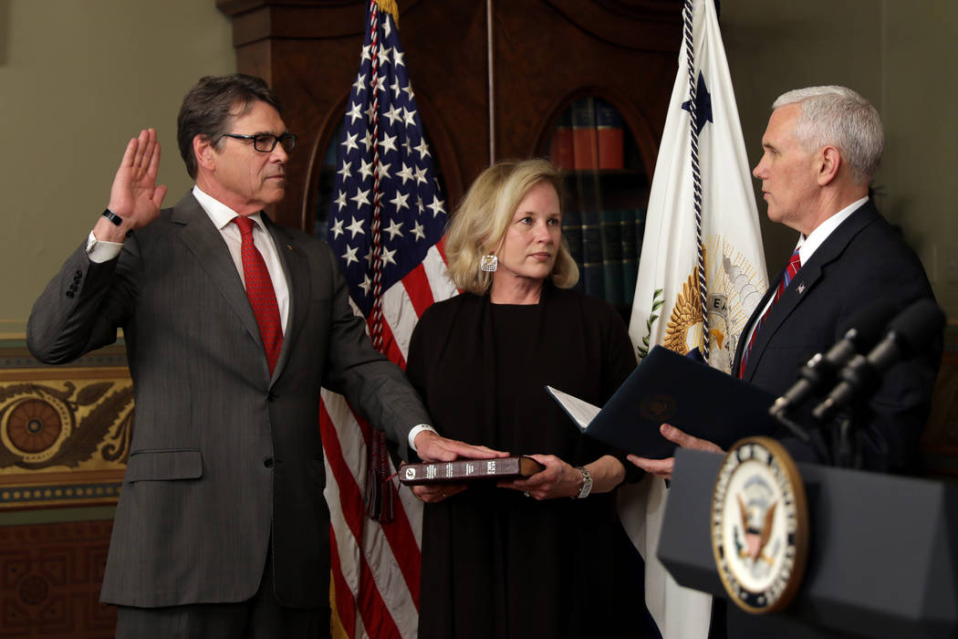New Secretary of Energy Rick Perry, left, is sworn in by Vice President Mike Pence as Perry's wife, Anita, holds a Bible during a ceremony in Washington, March 2, 2017. (Carlos Barria/Reuters)