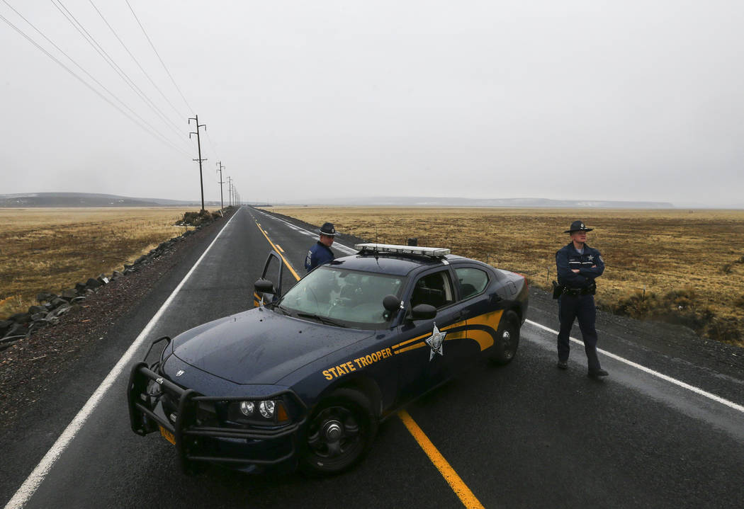 Oregon State Police block the road outside of the Malheur National Wildlife Refuge, where four anti-government protesters remain, about 30 miles south of Burns, Ore., on Thursday, Jan. 28, 2016. T ...