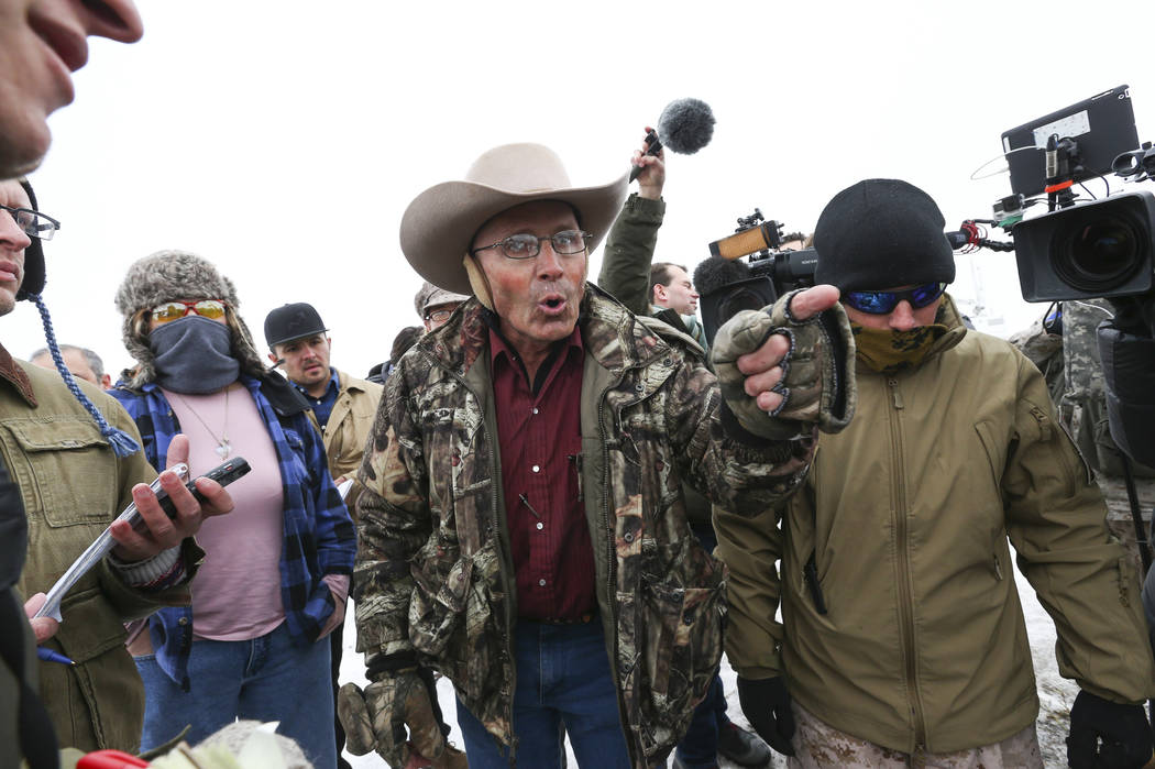 Arizona rancher and anti-government protestor LaVoy Finicum, center left, speaks during a news conference by the entrance to the Malheur National Wildlife Refuge headquarters, which the group is o ...