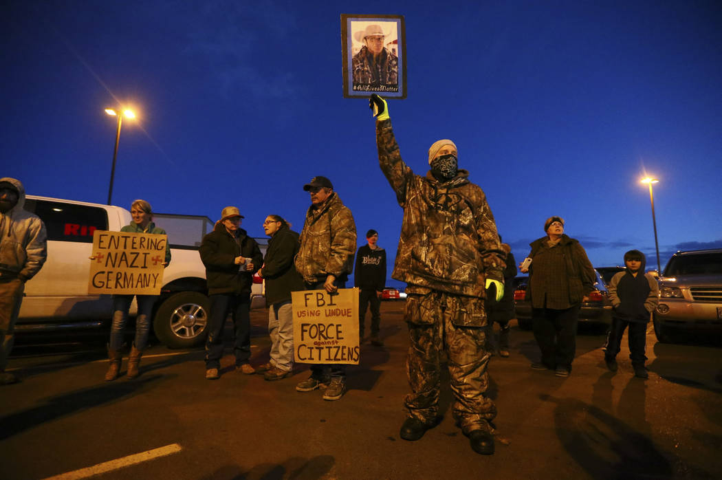 People gather for a "rolling" protest of the shooting death of LaVoy Finicum, who was killed Tuesday night during an attempted arrest by FBI and Oregon State Police officers, outside of Harney Cou ...