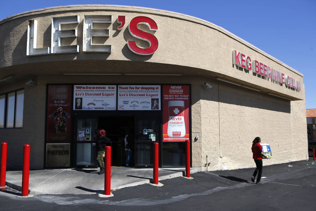 Customers walk out of the store as an employee dispose of used liquor boxes at Lee's Discount Liquor located at 1780 S Rainbow Blvd, on Tuesday, Feb. 28, 2017, in Las Vegas. (Christian K. Lee/Las  ...