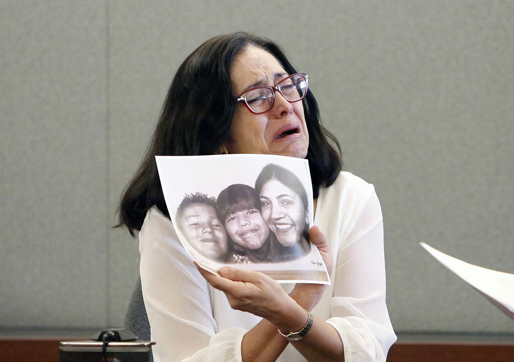 Martha Righetti, mother of Javier Righetti, gets emotional as she displays a picture of her children while testifying at her son's penalty hearing at the Regional Justice Center on Tuesday, March  ...