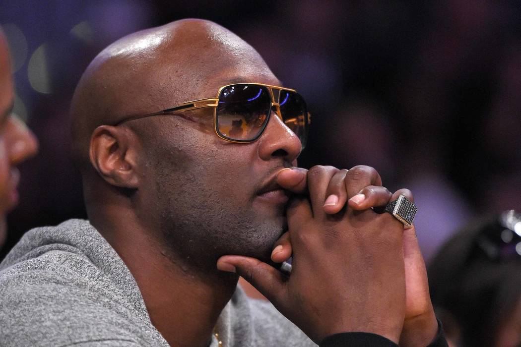 In this March 30, 2016, file photo, former Los Angeles Lakers' player Lamar Odom watches during the second half of an NBA basketball game between the Lakers and the Miami Heat in Los Angeles. Odom ...