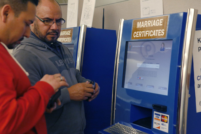 Raul Luna, 37, left, and Luis Zamarripa, 49,  right, purchase their marriage certificate at the Clark County Marriage License Bureau on Tuesday, Feb. 21, 2017, in Las Vegas. (Christian K. Lee/Las  ...
