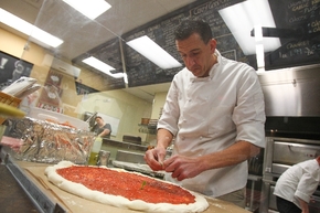 Owner Giovanni Mauro, shown at Old School Pizzeria, makes a dough that becomes an ultra-stretchy crust full of bubbles.