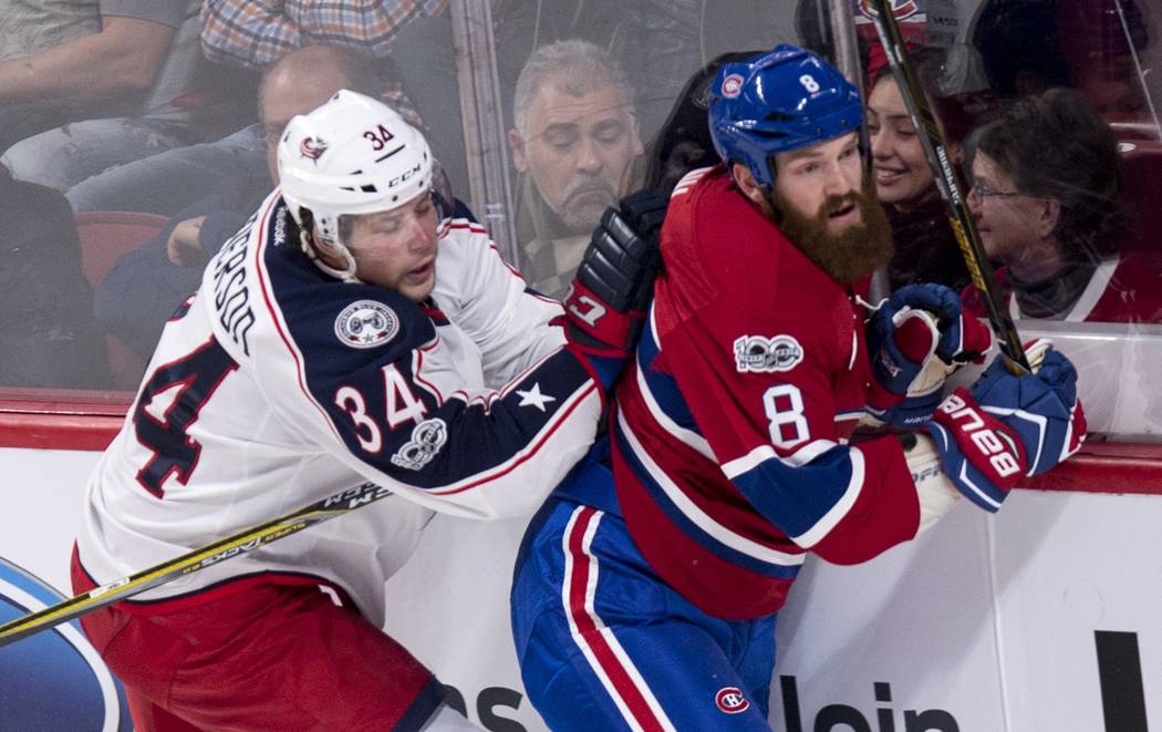 Montreal Canadiens' Jordie Benn is checked by Columbus Blue Jackets' Josh Anderson during the first period of an NHL hockey game, Tuesday, Feb. 28, 2017 in Montreal. (Paul Chiasson/The Canadian Pr ...