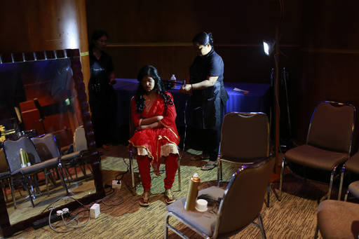 In this March 7, 2017 photo, a Bangladeshi acid attack survivor gets her make up applied during the event 'Beauty Redefined' in Dhaka, Bangladesh. (A.M. Ahad/AP)