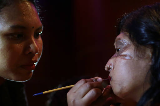 In this March 7, 2017 photo, a Bangladeshi acid attack survivor gets her make up applied during the event 'Beauty Redefined' in Dhaka, Bangladesh. Organizers said they hoped to highlight the fact  ...