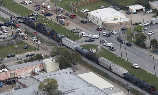 Responders works the scene where a train hit a bus in Biloxi, Miss., Tuesday, March 7, 2017. A freight train smashed into a charter bus in Biloxi, Mississippi, on Tuesday, pushing the bus 300 feet ...