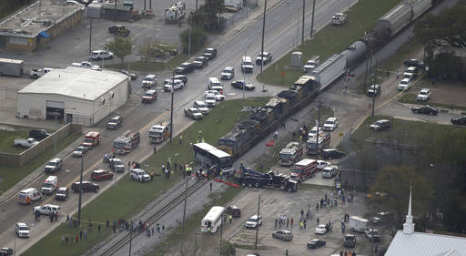 Responders works the scene where a train hit a bus in Biloxi, Miss., Tuesday, March 7, 2017.  A freight train smashed into a charter bus in Biloxi, Mississippi, on Tuesday, pushing the bus 300 fee ...