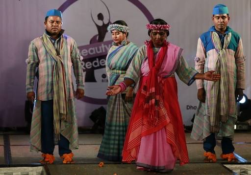 In this March 7, 2017 photo, Bangladeshi acid attack survivor walk down the catwalk during the event 'Beauty Redefined' in Dhaka, Bangladesh. The models, including three men, walked the catwalk, d ...