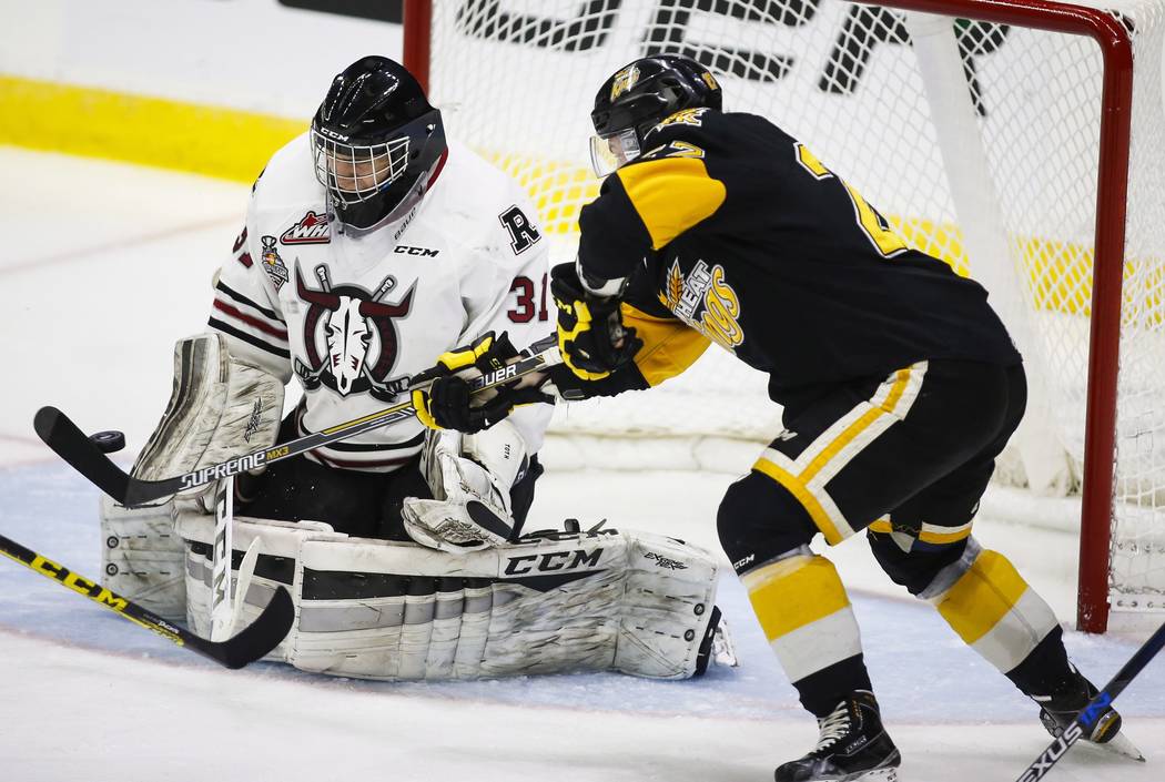 Brandon Wheat Kings' Reid Duke, right, tries to tip the puck past Red Deer Rebels goalie Rylan Toth during second period CHL Memorial Cup hockey action in Red Deer, Wednesday, May 25, 2016.(Jeff M ...