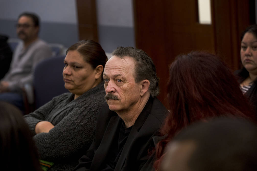 James Bush, center, sits with his wife Kristin Bush, right, while they wait to begin their initial arraignment for charges of child abuse after Kristin Bush's 13-year-old son died, weighing 22 pou ...