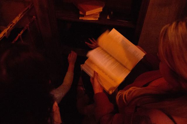 Participants page through books and look for hints, clues, keys or other materials that might help them find their way out at The Basement Escape Room in Las Vegas. Everything in the room could be ...