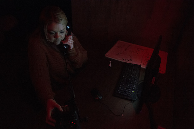 Participant Ashleigh Herring dials numbers on a phone in search of clues at The Basement Escape Room in Las Vegas. (Bridget Bennett/Las Vegas Review-Journal) @bridgetkb