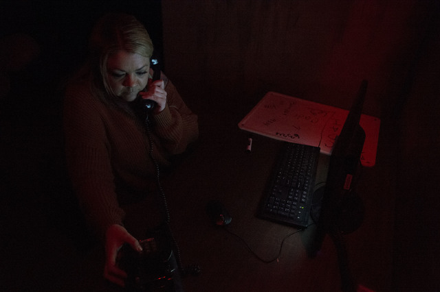 Participant Ashleigh Herring dials numbers on a phone in search of clues at The Basement Escape Room in Las Vegas. (Bridget Bennett/Las Vegas Review-Journal) @bridgetkb
