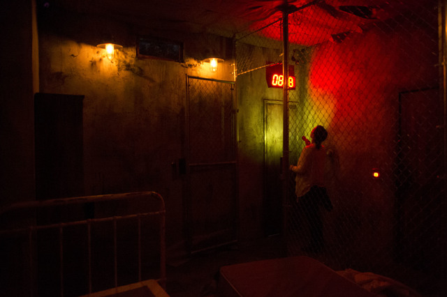Tori Young, a participant at The Basement escape room, checks the clock during a recent game. Teams have 45 minutes to find clues and solve puzzles to escape the basement of a hypothetical serial  ...