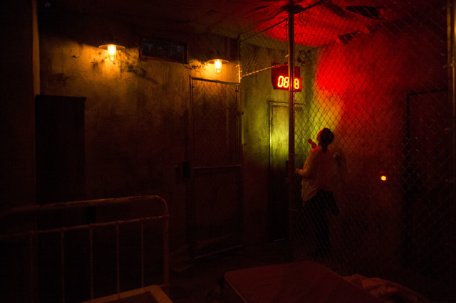 Tori Young, a participant at The Basement escape room, checks the clock during a recent game. Teams have 45 minutes to find clues and solve puzzles to escape the basement of a hypothetical serial ...