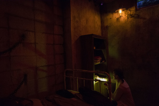 Participant Tori Young looks through a shelf for clues at The Basement. (Bridget Bennett/Las Vegas Review-Journal) @bridgetkb