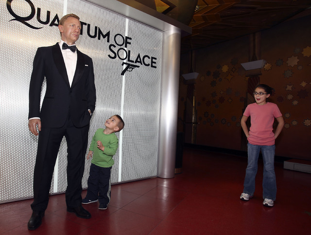A wax figure of actor Daniel Craig in his James Bond 007 persona seems to intrigue three-year-old Gavin Schiavone as he visits Madame Tussaud's wax museum inside The Venetian hotel-casino in Las V ...