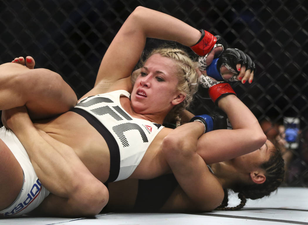 Amanda Cooper of the United States tries to escape a rear-naked choke from Cynthia...