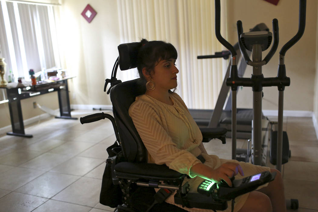 Sharona Dagani crosses the living room at her home in San Antonio, Texas on Sunday, March 12, 2017. The 29-year-old, Dagani, born with cerebral palsy, is one of hundreds of former clients whose fu ...