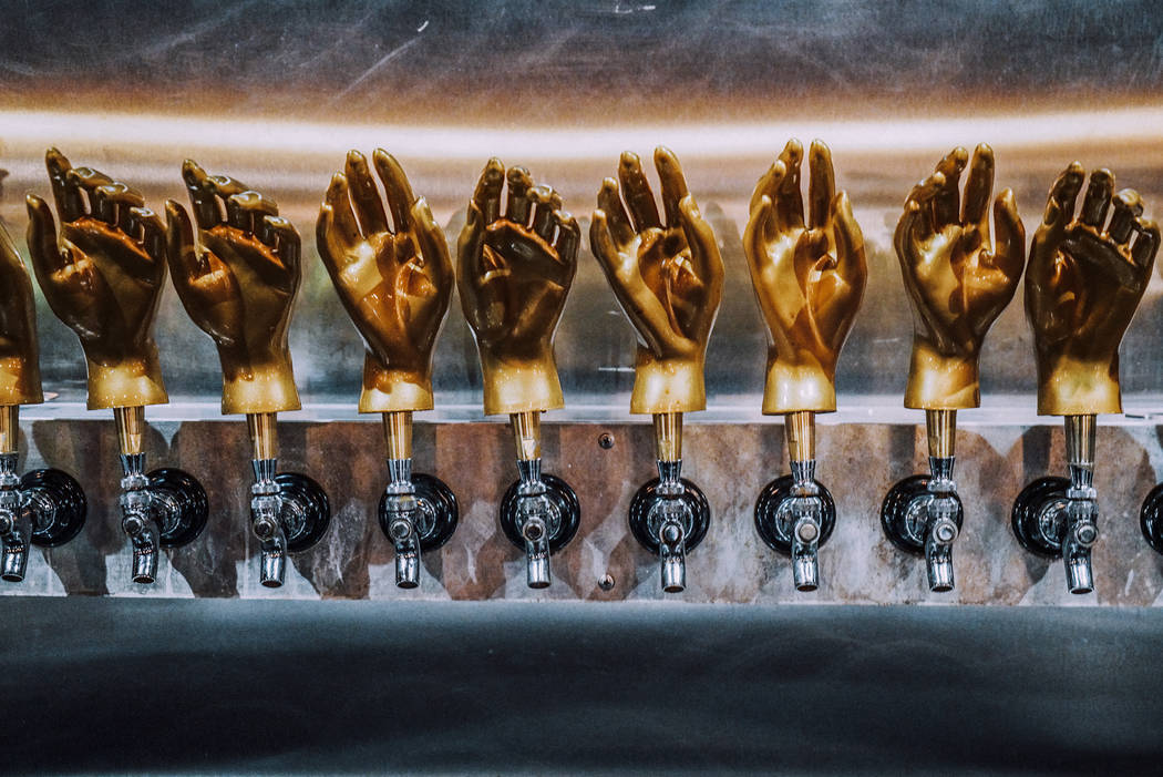The Velveteen Rabbit's metallic tap handles, shown here, match the rest of the bar's aesthetic: jewel toned and dream-like.