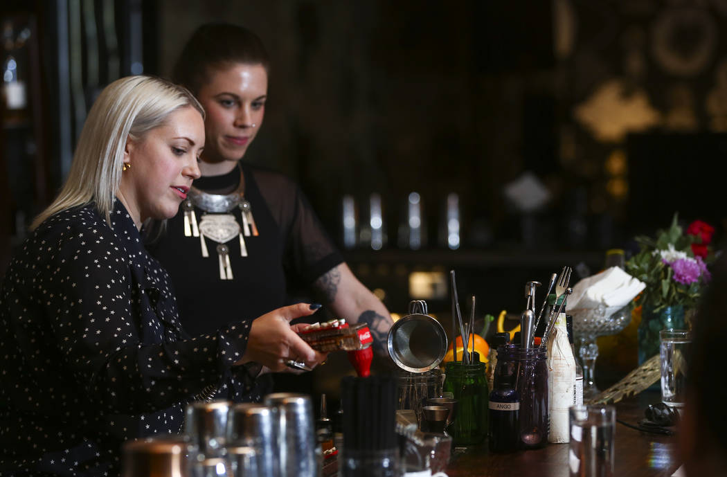 Instructor Pamela Dylag, left, demonstrates the creation of an old fashioned as Christina Dylag looks on during a cocktail class at Velveteen Rabbit in downtown Las Vegas on Saturday, Feb. 25, 201 ...