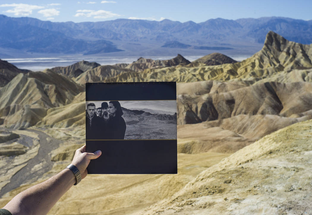 Zabriskie Point, featured in the album artwork of U2's 1987 album &quot;The Joshua Tree,&quot; is shown with a copy of the album in Death Valley National Park on Tuesday, Feb. 28, 2017. (C ...