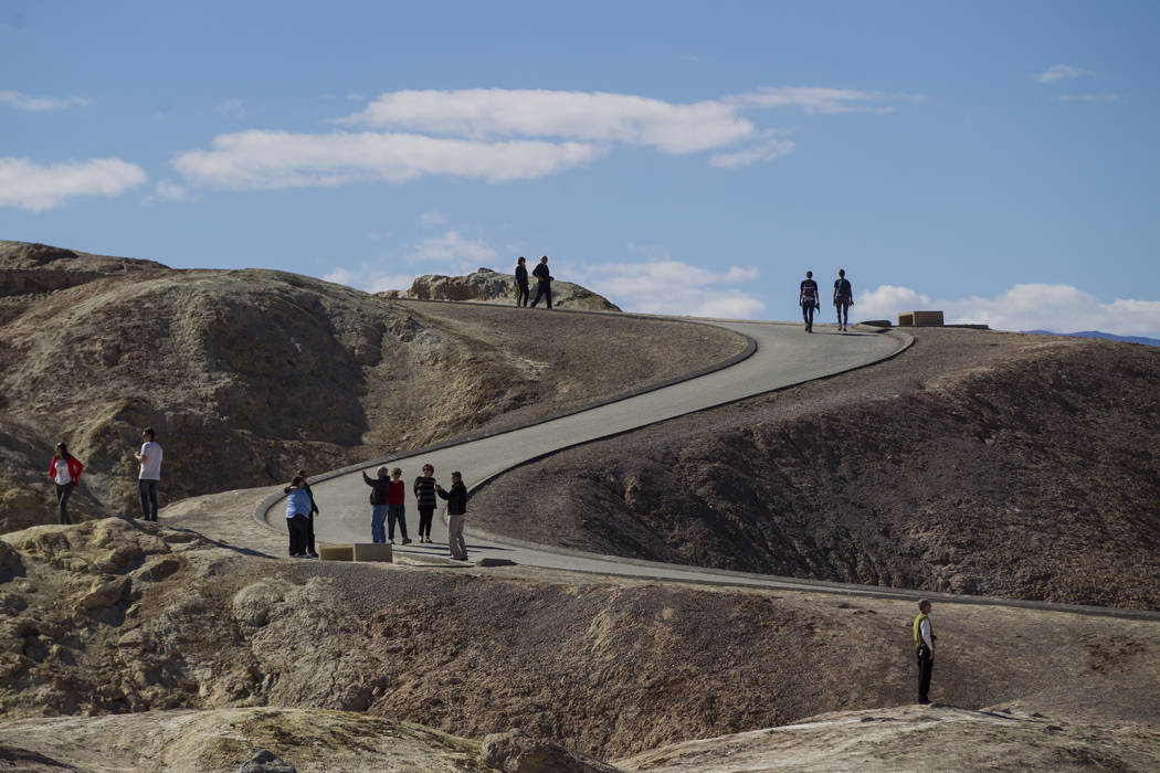 People at Zabriskie Point in Death Valley National Park on Tuesday, Feb. 28, 2017. The cover art of rock band U2's "The Joshua Tree" was taken at the popular tourist spot at the ...