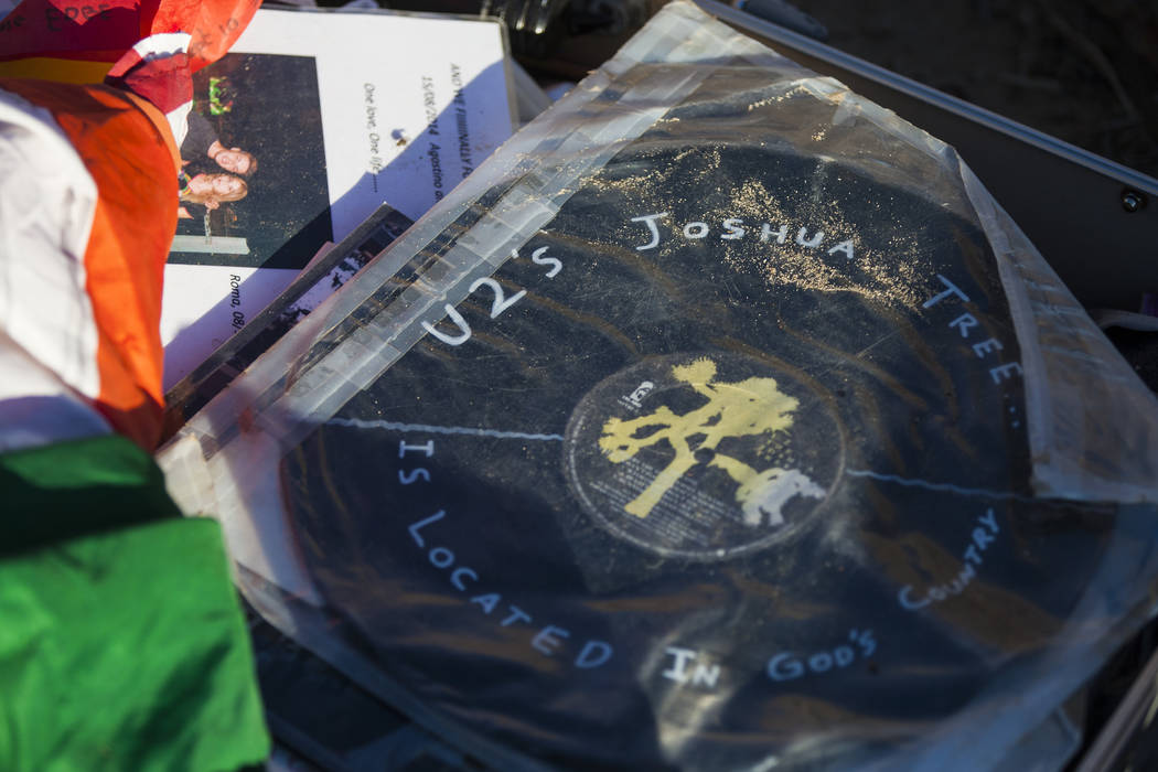 A briefcase with tributes and memorabilia from fans of rock band U2 sits with the fallen tree that appeared in the band's 1987 album "The Joshua Tree" outside of Death Valley Nat ...