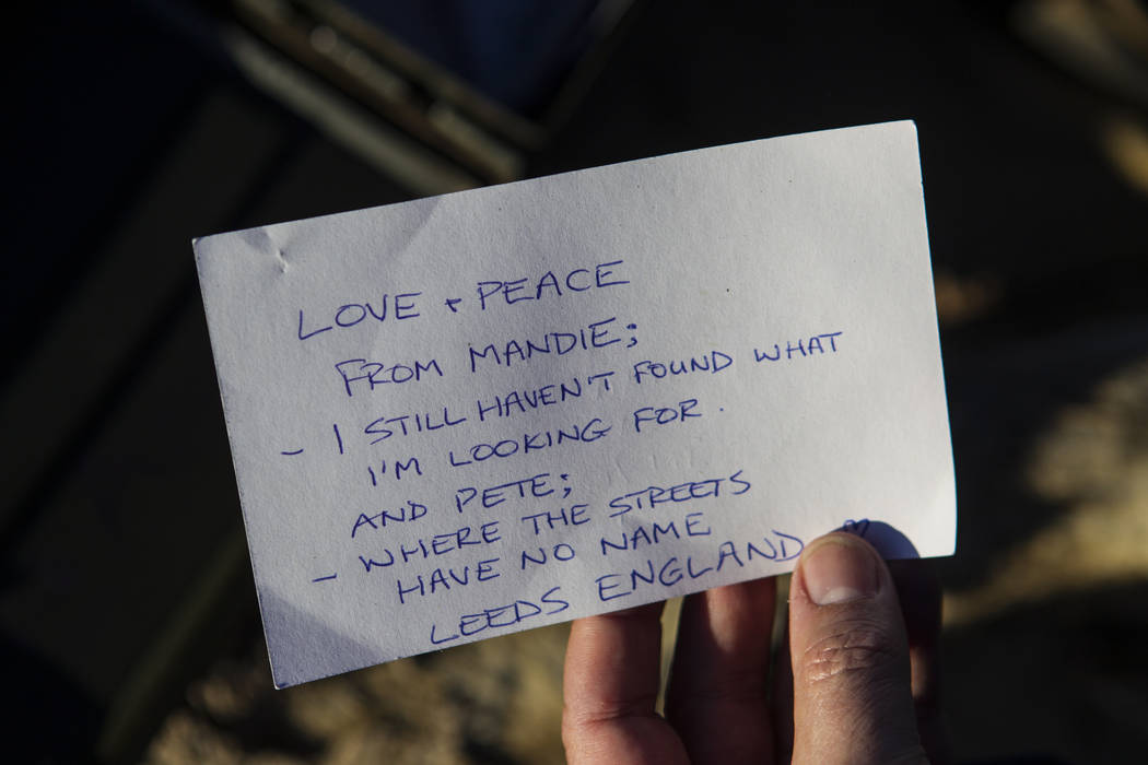 A note left by a fan of rock band U2 sits with the fallen tree that appeared in the band's 1987 album "The Joshua Tree" outside of Death Valley National Park along California Sta ...