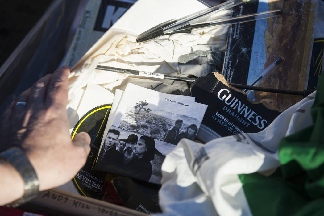 A briefcase with tributes and memorabilia from fans of rock band U2 sits with the fallen tree that appeared in the band's 1987 album "The Joshua Tree" outside of Death Valley Nat ...