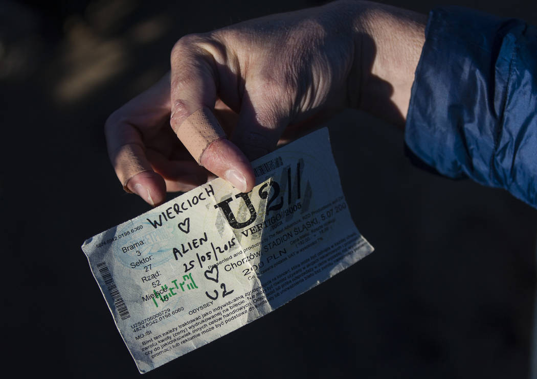 An old concert ticket left by fans of rock band U2 sits with the fallen tree that appeared in the band's 1987 album "The Joshua Tree" outside of Death Valley National Park along ...