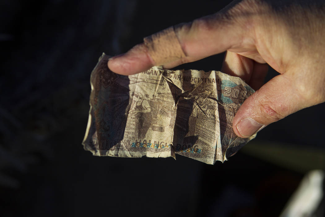 Money left by fans of rock band U2 sits with the fallen tree that appeared in the band's 1987 album "The Joshua Tree" outside of Death Valley National Park along California State ...