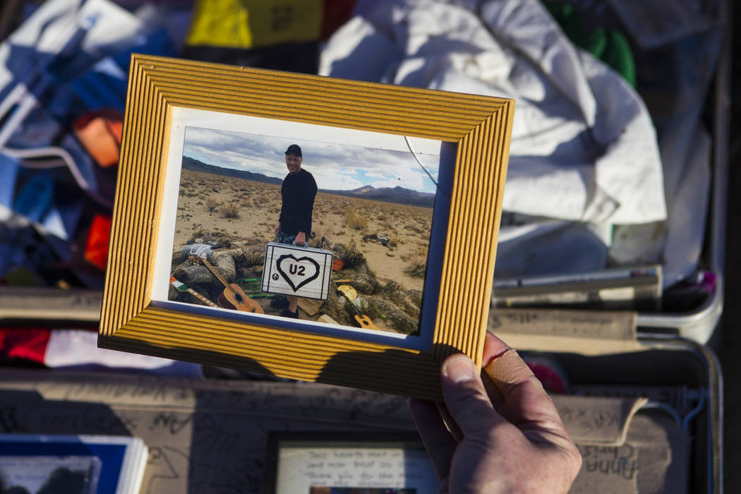 A photo left by fans of rock band U2 sits with the fallen tree that appeared in the band's 1987 album &quot;The Joshua Tree&quot; outside of Death Valley National Park along California Sta ...