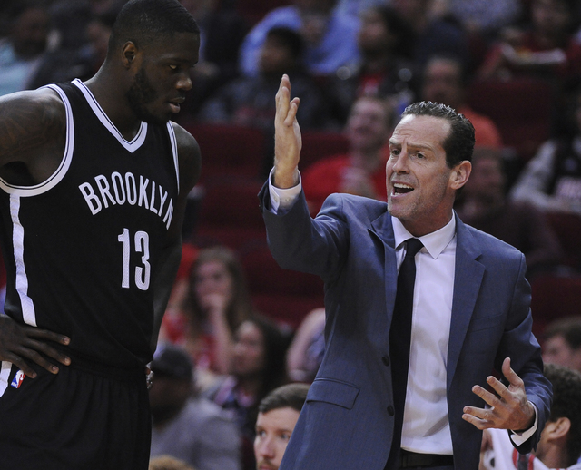 Brooklyn Nets head coach Kenny Atkinson gives instructions to Anthony Bennett (13) as they face the Houston Rockets in the first half of an NBA basketball game on Monday, Dec. 12, 2016, in Houston ...