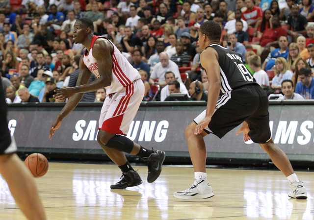 Cleveland's Anthony Bennett (15) drives the ball past Houston's Andre Dawkins (19) defends during an NBA Summer League game at the Thomas & Mack Center in Las Vegas on Thursday, July 17, 2014. ...