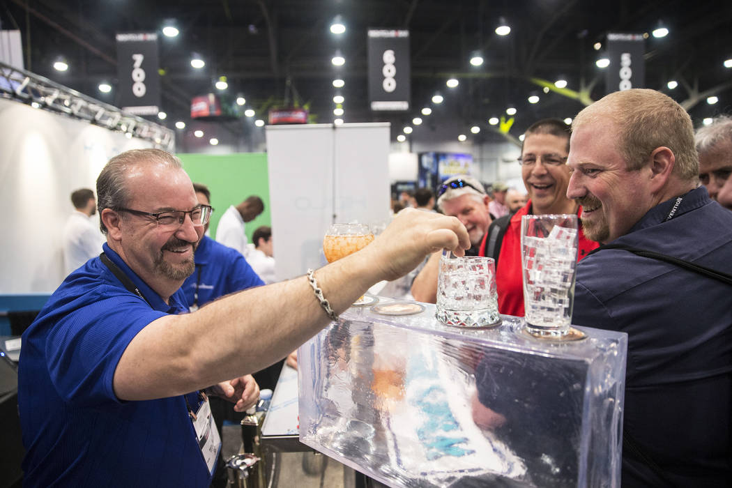 Manitowoc Ice distributor Pete Palm, left, highlights the different shapes and sizes of ice his trays produce during the 2017 Nightclub & Bar Show at the Las Vegas Convention Center on Tuesday ...