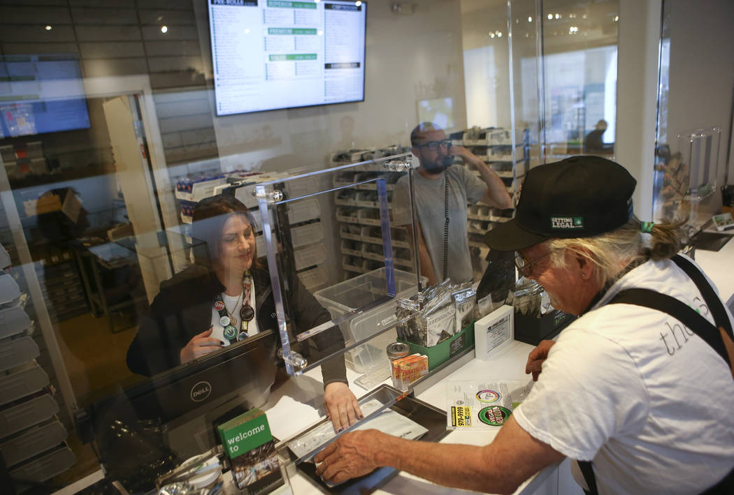 Kat Hernandez, left, a teller at medical marijuana dispensary The Source, assists Donald Solo in Las Vegas on Thursday, March 30, 2017. (Chase Stevens/Las Vegas Review-Journal) @csstevensphoto