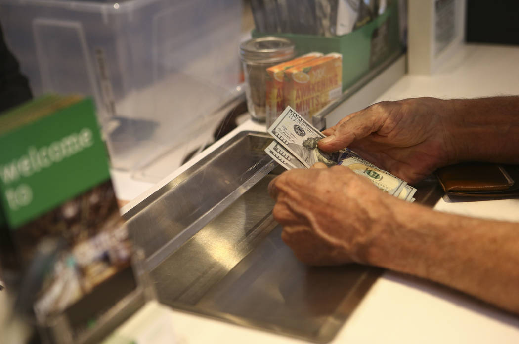 Donald Solo prepares to pay for products at medical marijuana dispensary The Source in Las Vegas on Thursday, March 30, 2017. (Chase Stevens/Las Vegas Review-Journal) @csstevensphoto