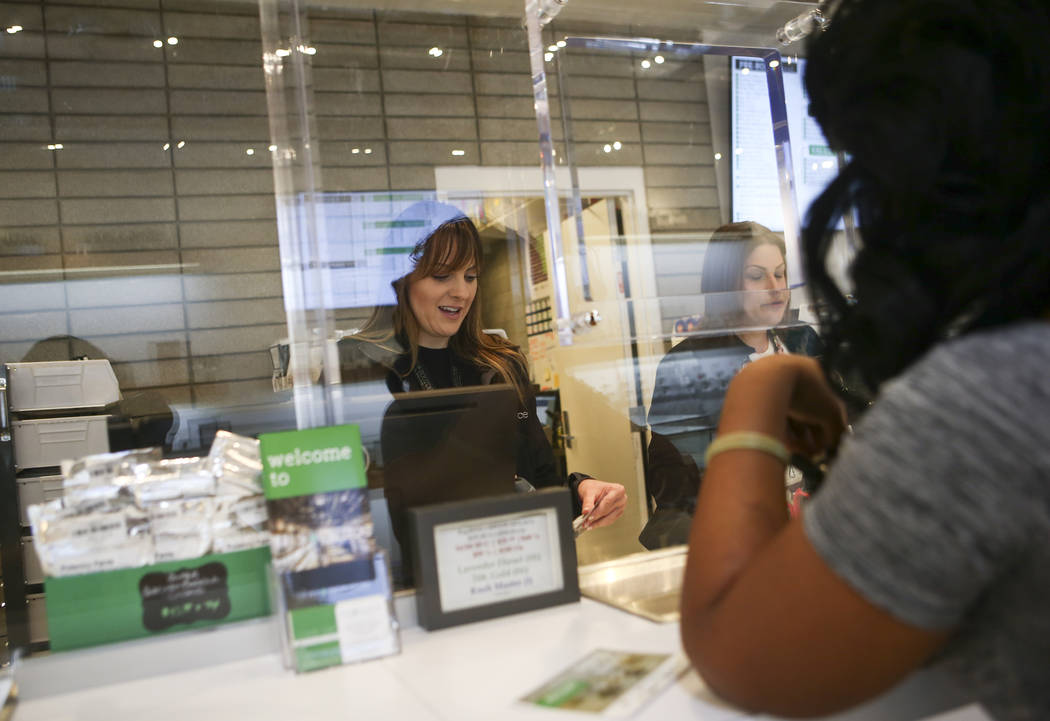 Jennifer, right, is assisted by Mandy, a teller at medical marijuana dispensary The Source, in Las Vegas on Thursday, March 30, 2017. (Chase Stevens/Las Vegas Review-Journal) @csstevensphoto
