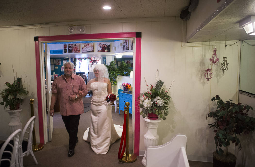 Lauren Santiago is walked down the aisle by her father George during her wedding ceremony at the Little Vegas Chapel in Las Vegas on Saturday, April 1, 2017. (Chase Stevens/Las Vegas Review-Journa ...
