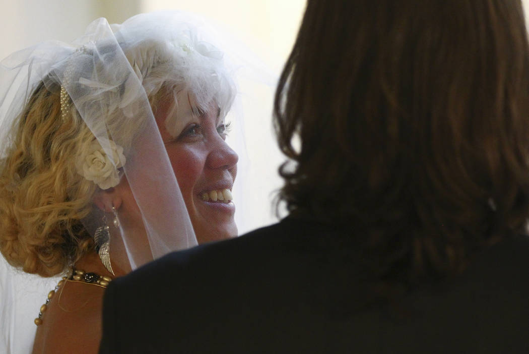 Lauren Santiago, left, and David Wenzel during their wedding ceremony at the Little Vegas Chapel in Las Vegas on Saturday, April 1, 2017. (Chase Stevens/Las Vegas Review-Journal) @csstevensphoto