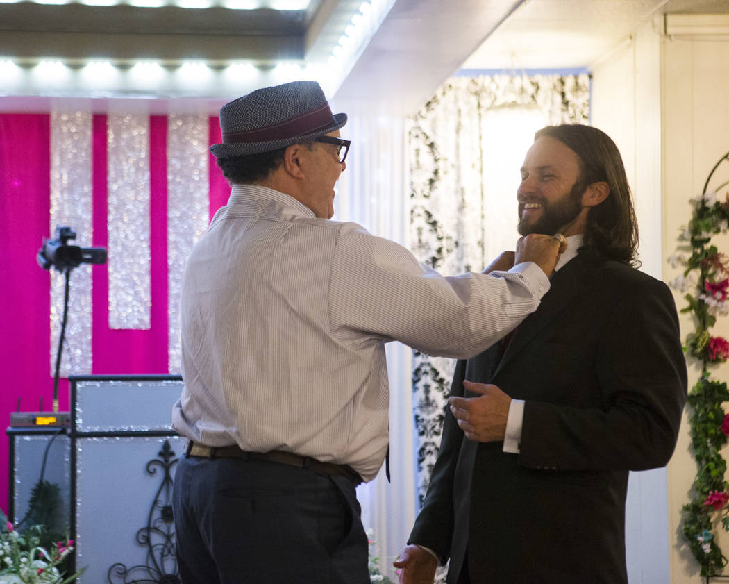 Albert Guillermo, uncle of the bride, left, adjusts the tie groom David Wenzel before his wedding at the Little Vegas Chapel in Las Vegas on Saturday, April 1, 2017. (Chase Stevens/Las Vegas Revie ...