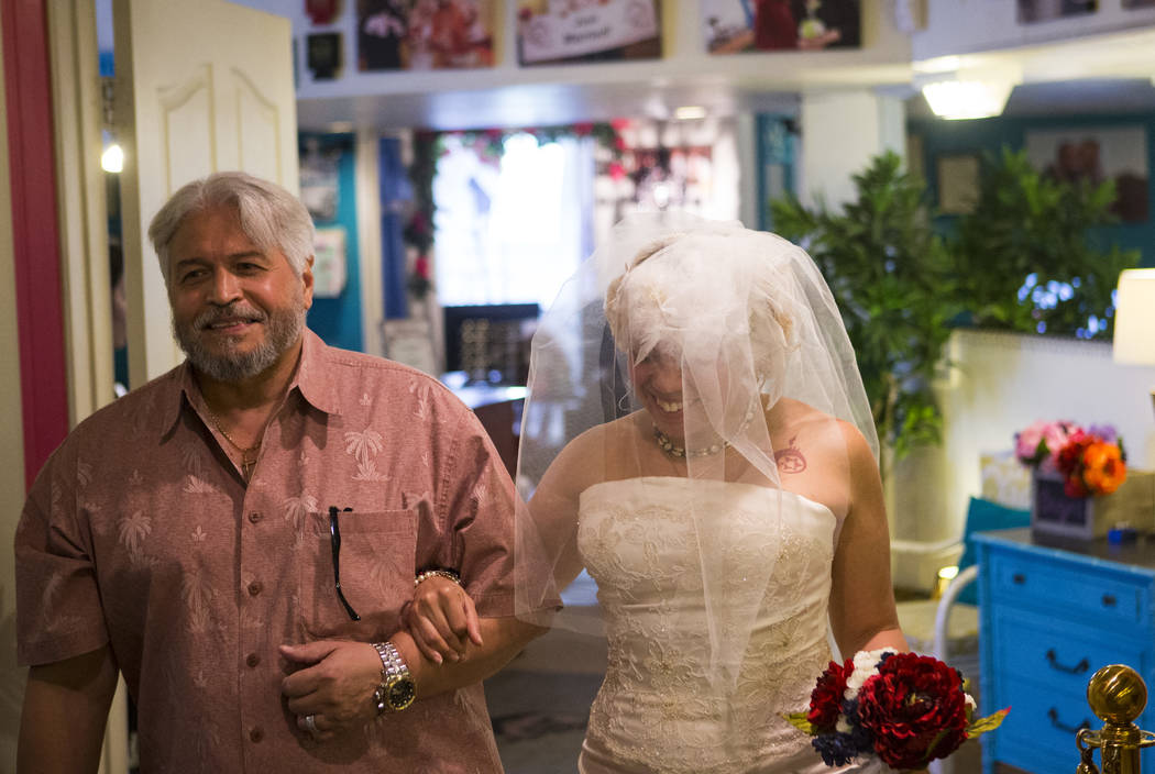 Lauren Santiago is walked down the aisle by her father George during her wedding ceremony at the Little Vegas Chapel in Las Vegas on Saturday, April 1, 2017. (Chase Stevens/Las Vegas Review-Journa ...